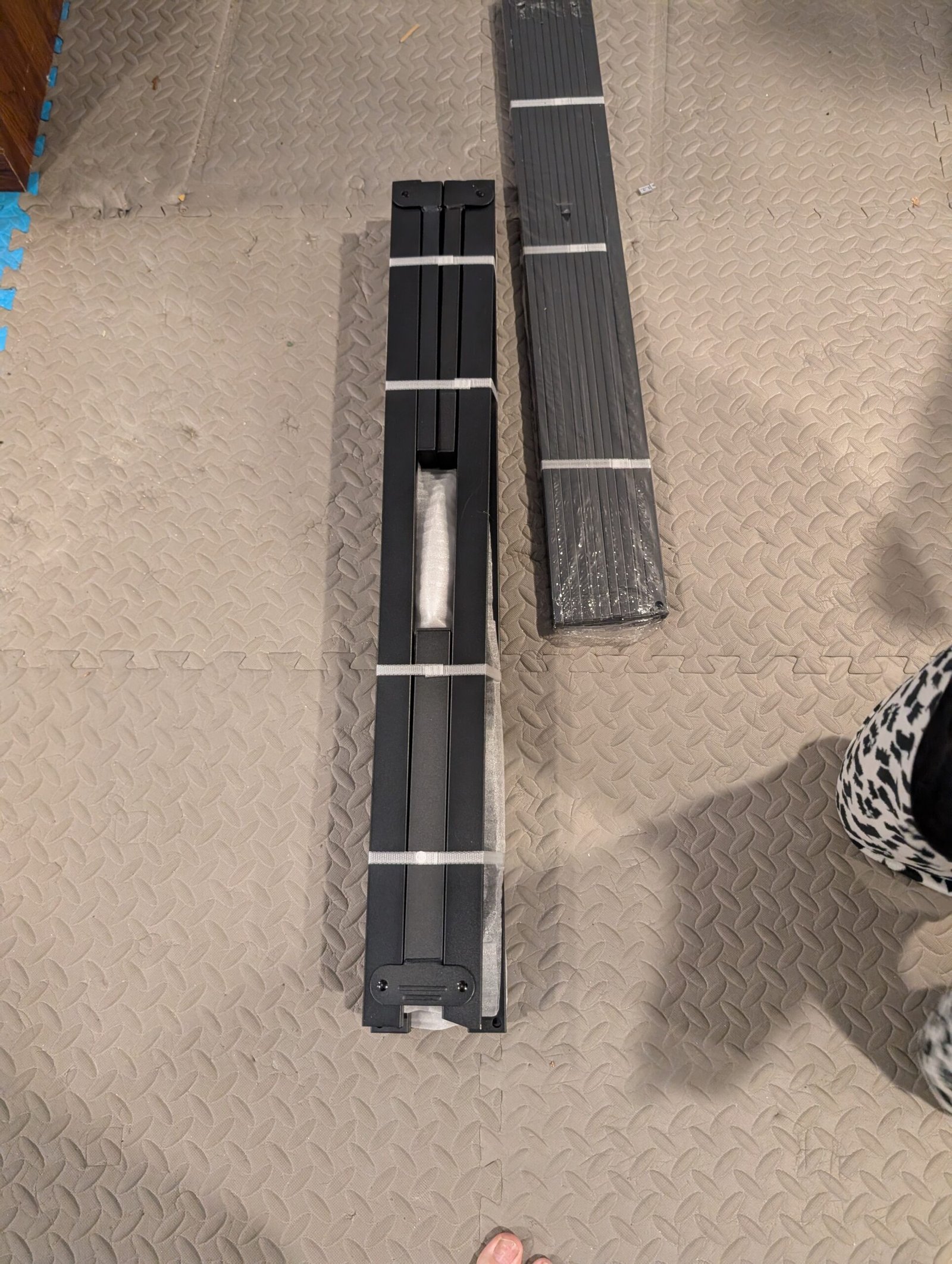 Frame still bundled up, unassembled, out of the package, laid on the floor