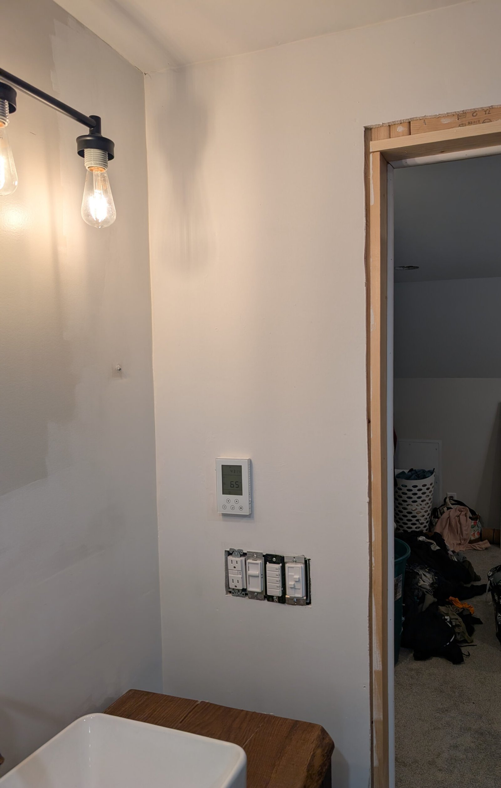 Wall primed and ready for paint, showing the smooth gray surface